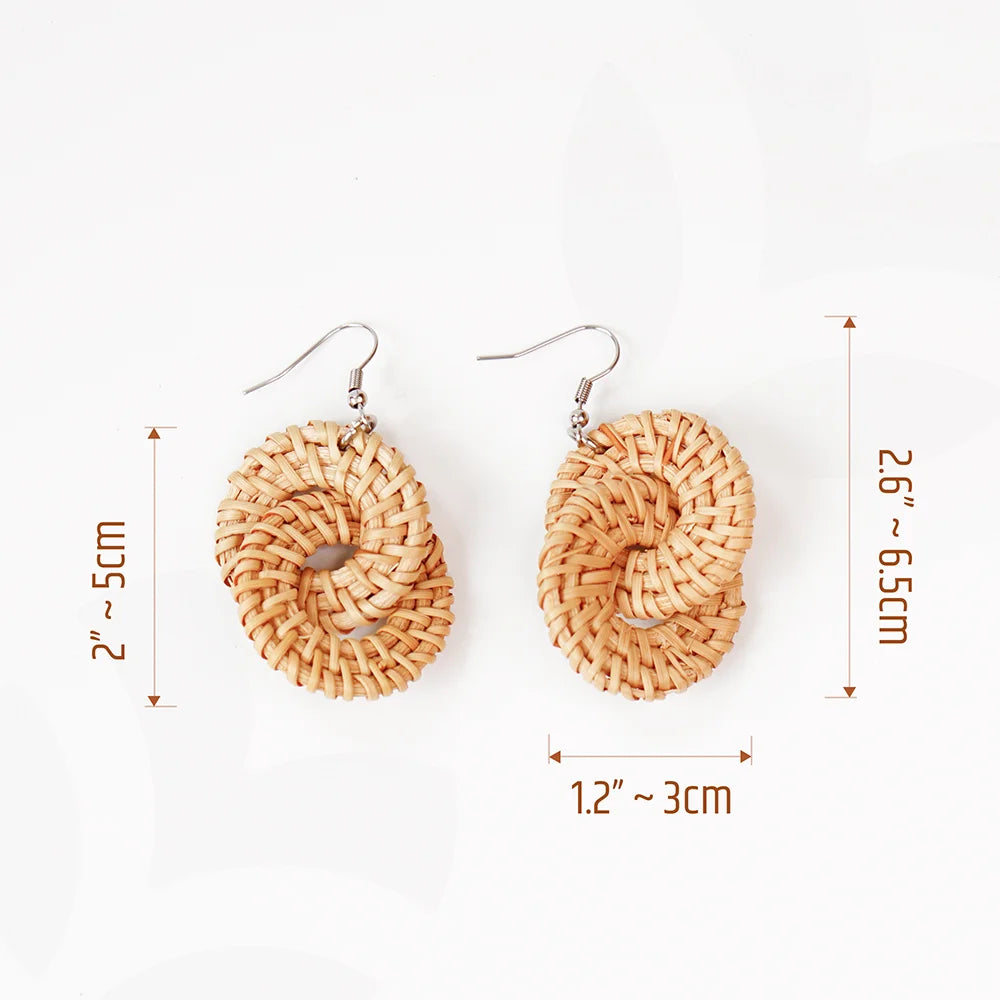 A pair of handcrafted rattan earrings with teardrop-shaped blue wooden beads, made by Mayvietstore. The earrings are made of high-quality rattan and wood, and are lightweight and comfortable to wear. The beads add a touch of elegance and sophistication to the earrings, while the rattan gives them a natural and earthy feel. These earrings are perfect for any occasion, from a casual day out to a special event.