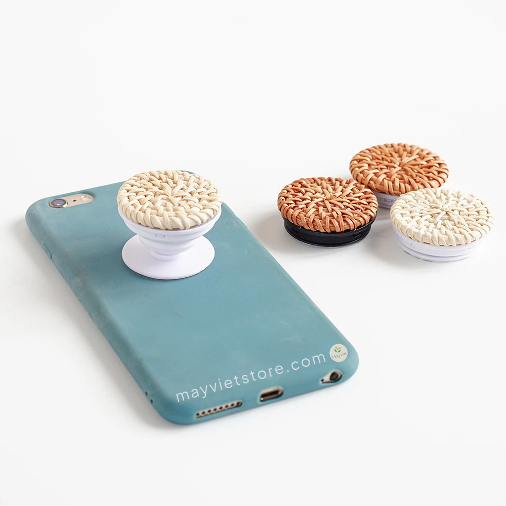 Handwoven rattan phone stand, phone holder, and pop socket in a minimalist design. Perfect for adding a touch of bohemian style to your home or office, or for using on the go.