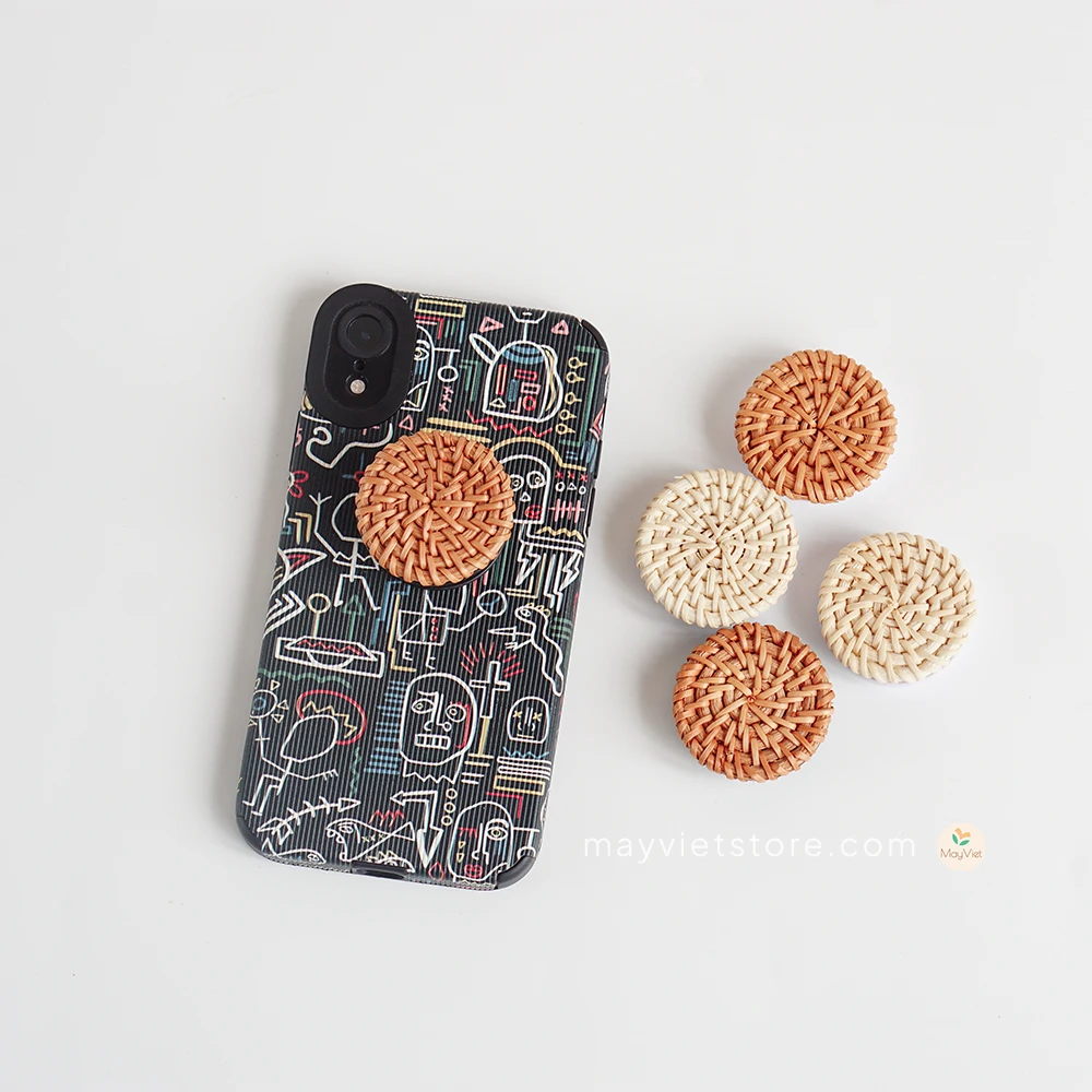 Handwoven rattan phone stand, phone holder, and pop socket in a minimalist design. Perfect for adding a touch of bohemian style to your home or office, or for using on the go.
