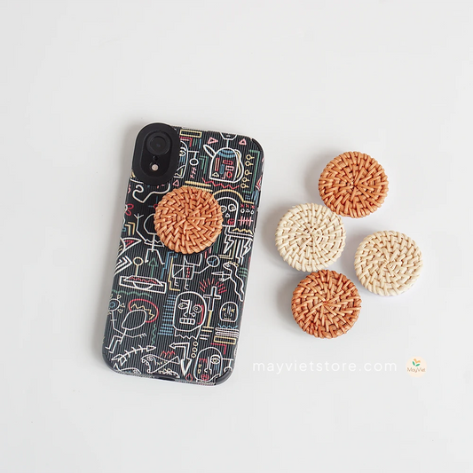 Handwoven rattan phone stand, phone holder, and pop socket in a minimalist design. Perfect for adding a touch of bohemian style to your home or office, or for using on the go.