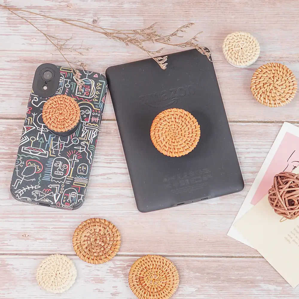Handwoven rattan phone stand, phone holder, and pop socket in a minimalist design. Perfect for adding a touch of bohemian style to your home or office, or for using on the go.