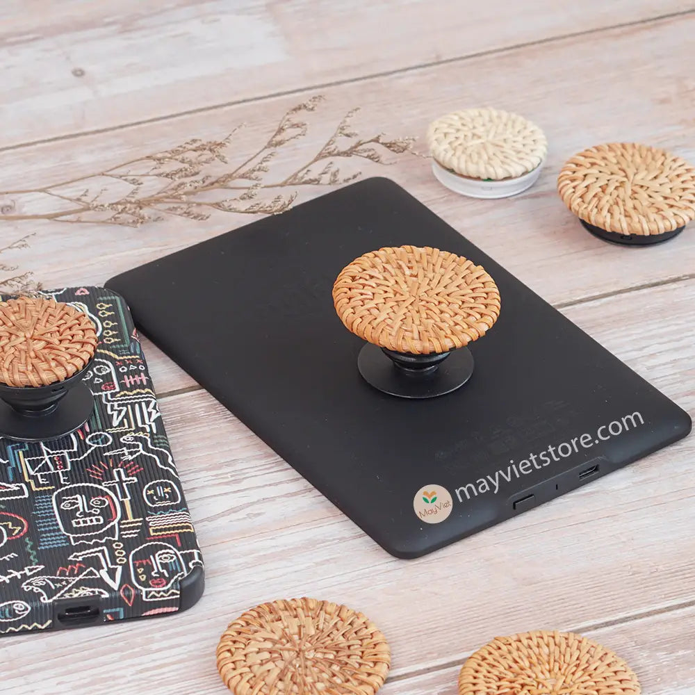 Handwoven rattan phone stand, phone holder, and pop socket in a minimalist design. Perfect for adding a touch of bohemian style to your home or office, or for using on the go.