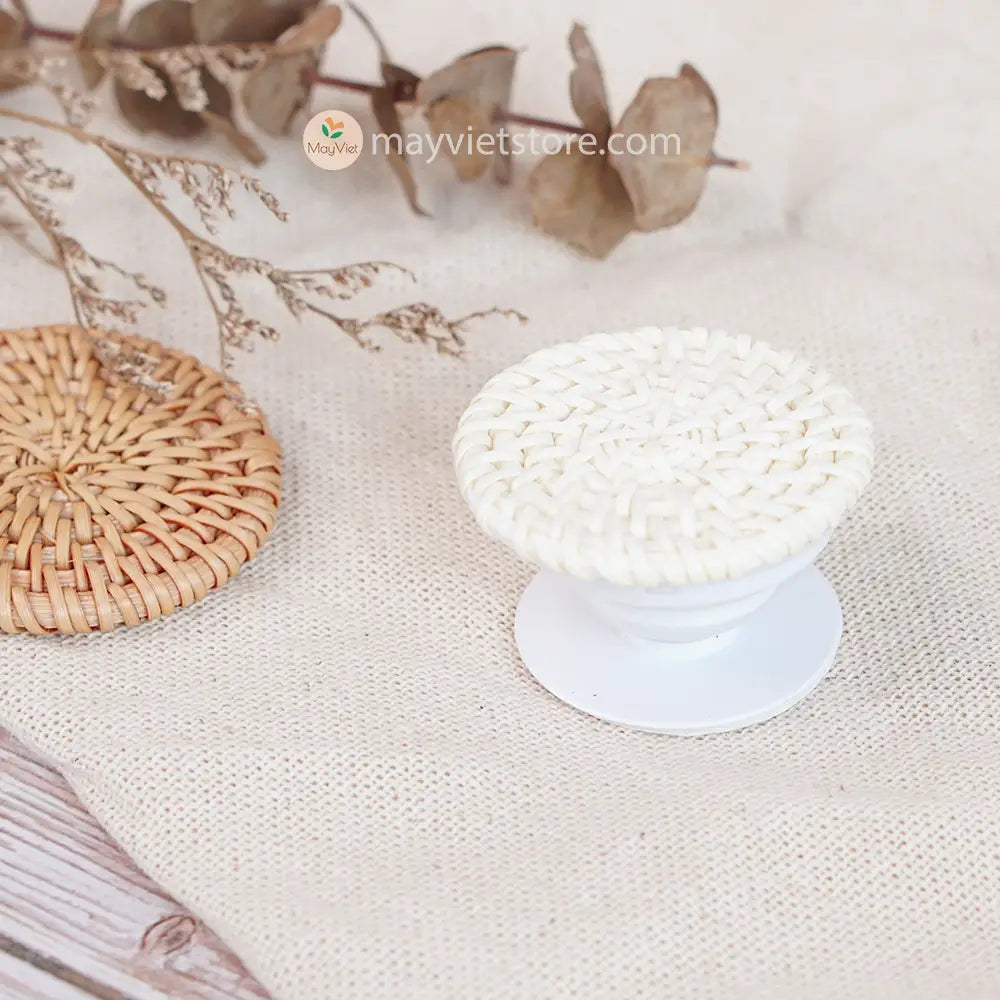 Handwoven rattan phone stand, phone holder, and pop socket in a minimalist design. Perfect for adding a touch of bohemian style to your home or office, or for using on the go.