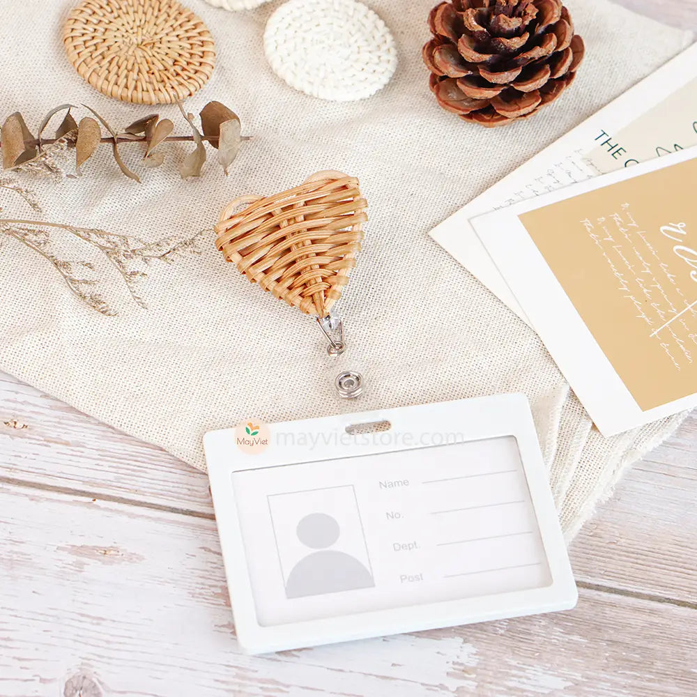 This badge reel clip/card holder is made of rattan. It has a retractable cord and a clip that can be attached to a belt or other clothing. The card holder has three slots for cards, such as a nurse's license and identification card.