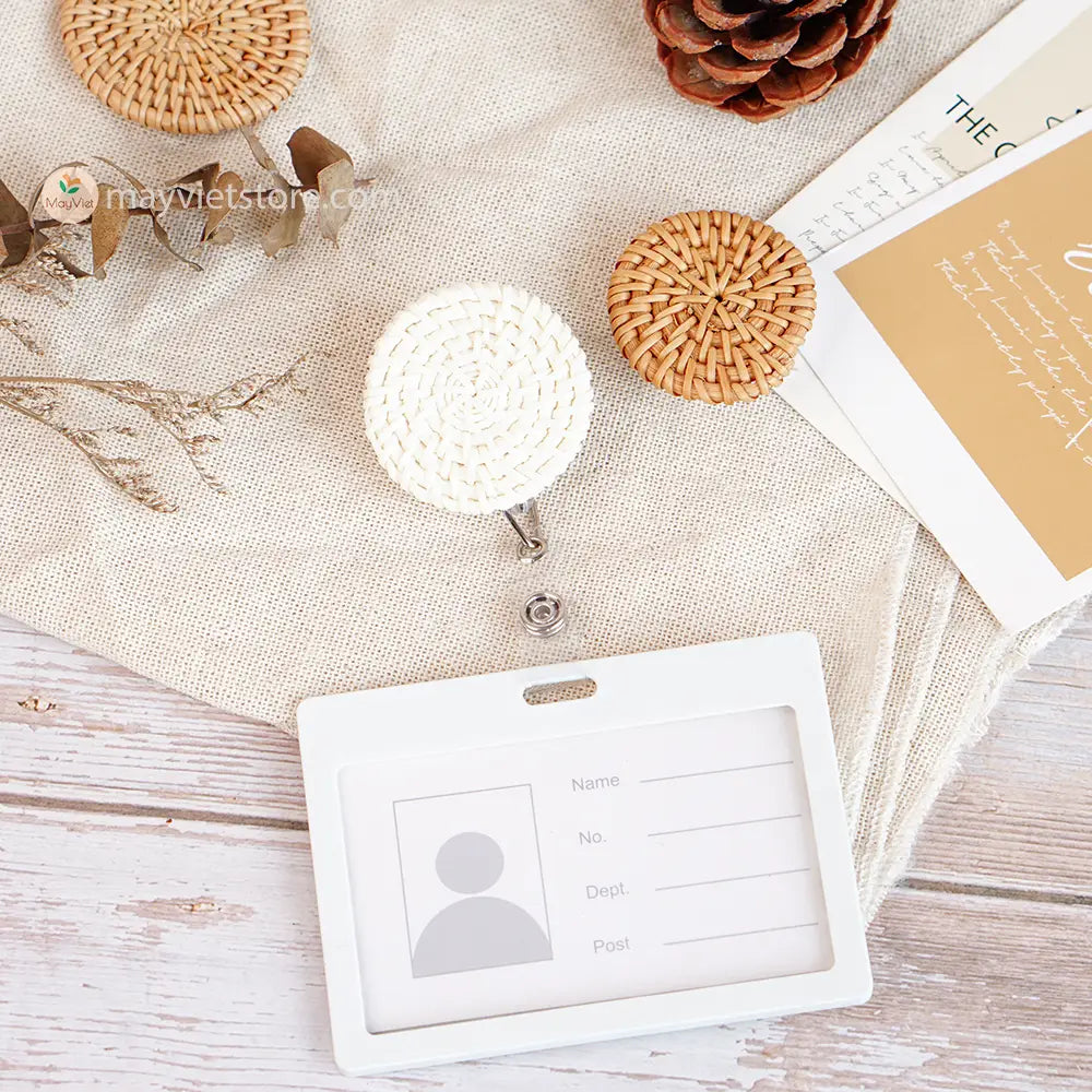 This badge reel clip/card holder is made of rattan. It has a retractable cord and a clip that can be attached to a belt or other clothing. The card holder has three slots for cards, such as a nurse's license and identification card.