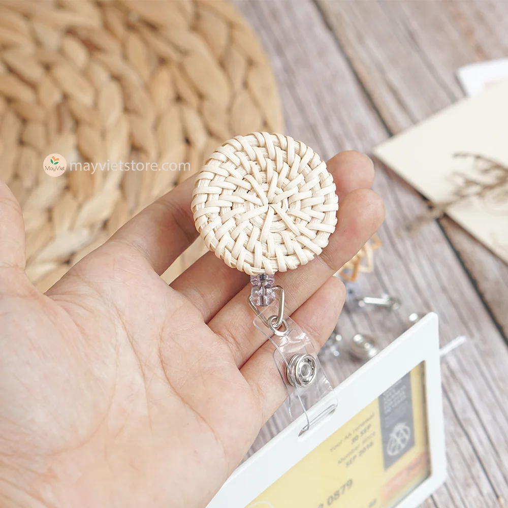 This badge reel clip/card holder is made of rattan. It has a retractable cord and a clip that can be attached to a belt or other clothing. The card holder has three slots for cards, such as a nurse's license and identification card.