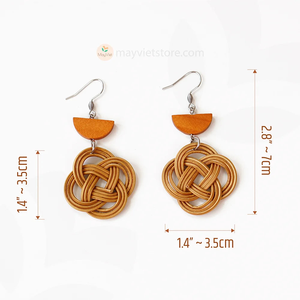 A pair of handcrafted rattan charm earrings with orange wooden beads, made by Mayvietstore. The earrings are made of high-quality rattan and wood, and are lightweight and comfortable to wear. The rattan charms add a touch of fun and personality to the earrings, while the orange wooden beads add a pop of color. These earrings are perfect for any occasion, from a casual day out to a special event.