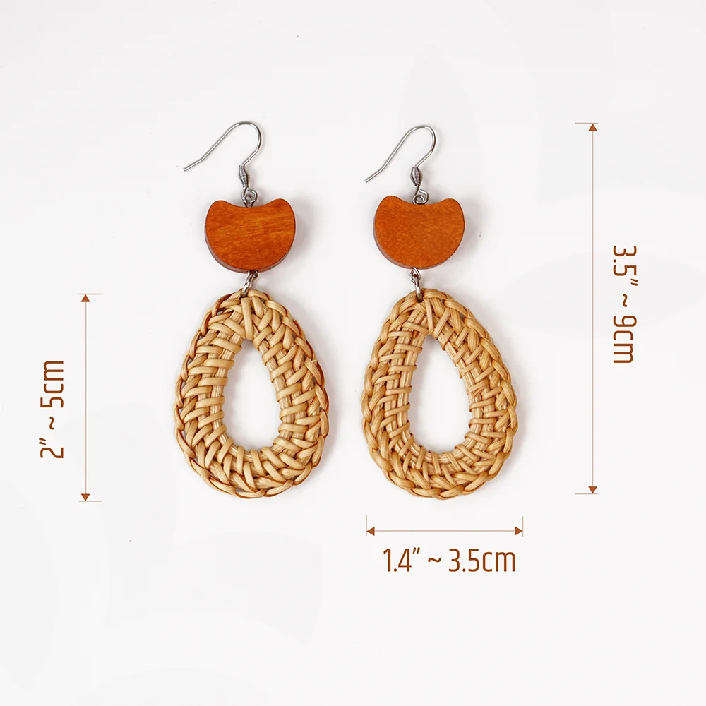 A pair of handcrafted rattan earrings with teardrop-shaped orange wooden beads, made by Mayvietstore. The earrings are made of high-quality rattan and wood, and are lightweight and comfortable to wear. The teardrop-shaped beads add a touch of elegance and sophistication to the earrings, while the rattan gives them a natural and earthy feel. The orange wooden beads add a pop of color and make the earrings stand out. These earrings are perfect for any occasion, from a casual day out to a special event.