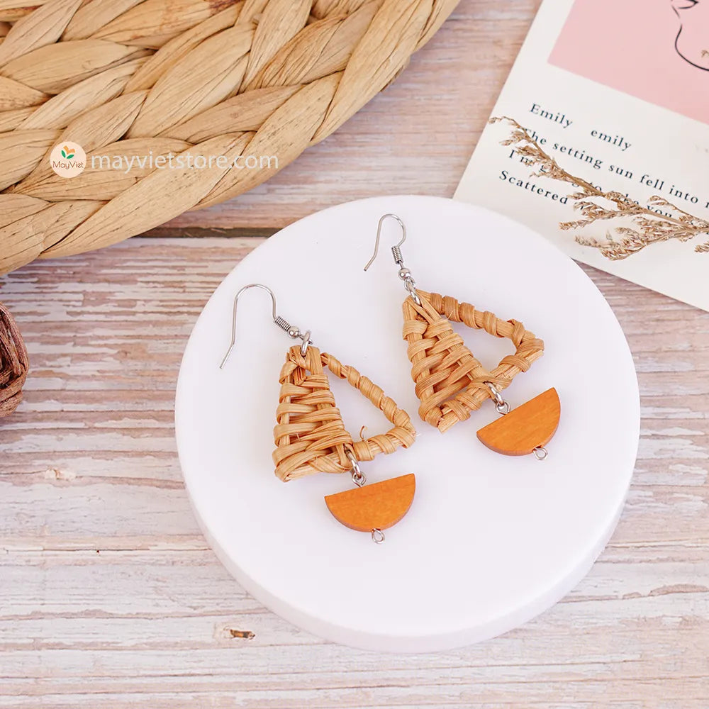 A pair of handcrafted rattan earrings with mini triangular brown wooden beads, made by Mayvietstore. The earrings are made of high-quality rattan and wood, and are lightweight and comfortable to wear. The mini triangular beads add a touch of delicate and minimalist style to the earrings, and the brown wooden beads give them a warm and natural look. These earrings are perfect for any occasion, from a casual day out to a special event.
