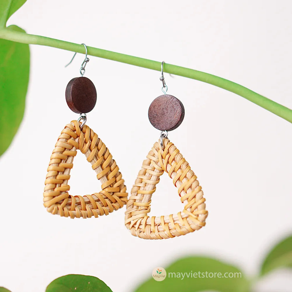 A pair of handcrafted rattan earrings with triangular brown wooden beads, made by Mayvietstore. The earrings are made of high-quality rattan and wood, and are lightweight and comfortable to wear. The triangular beads add a touch of geometric interest to the earrings, and the brown wooden beads give them a warm and natural look. These earrings are perfect for any occasion, from a casual day out to a special event.