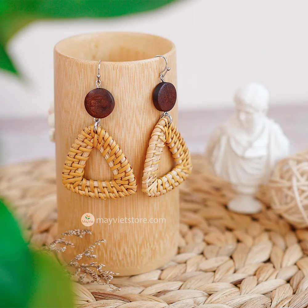 A pair of handcrafted rattan earrings with triangular brown wooden beads, made by Mayvietstore. The earrings are made of high-quality rattan and wood, and are lightweight and comfortable to wear. The triangular beads add a touch of geometric interest to the earrings, and the brown wooden beads give them a warm and natural look. These earrings are perfect for any occasion, from a casual day out to a special event.
