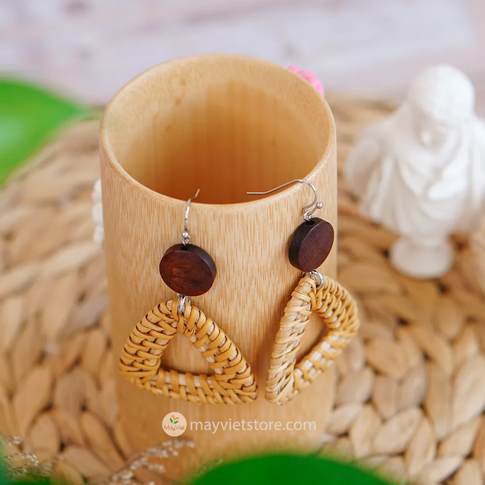A pair of handcrafted rattan earrings with triangular brown wooden beads, made by Mayvietstore. The earrings are made of high-quality rattan and wood, and are lightweight and comfortable to wear. The triangular beads add a touch of geometric interest to the earrings, and the brown wooden beads give them a warm and natural look. These earrings are perfect for any occasion, from a casual day out to a special event.