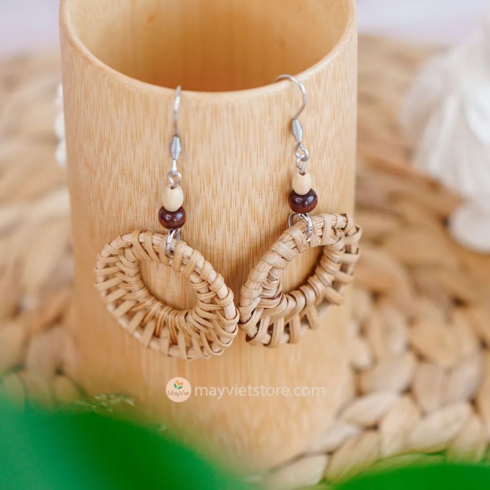A pair of mini rattan round earrings with wooden beads, handcrafted by Mayvietstore. The earrings are made of high-quality rattan and wood, and are lightweight and comfortable to wear. They are perfect for everyday wear or for special occasions.