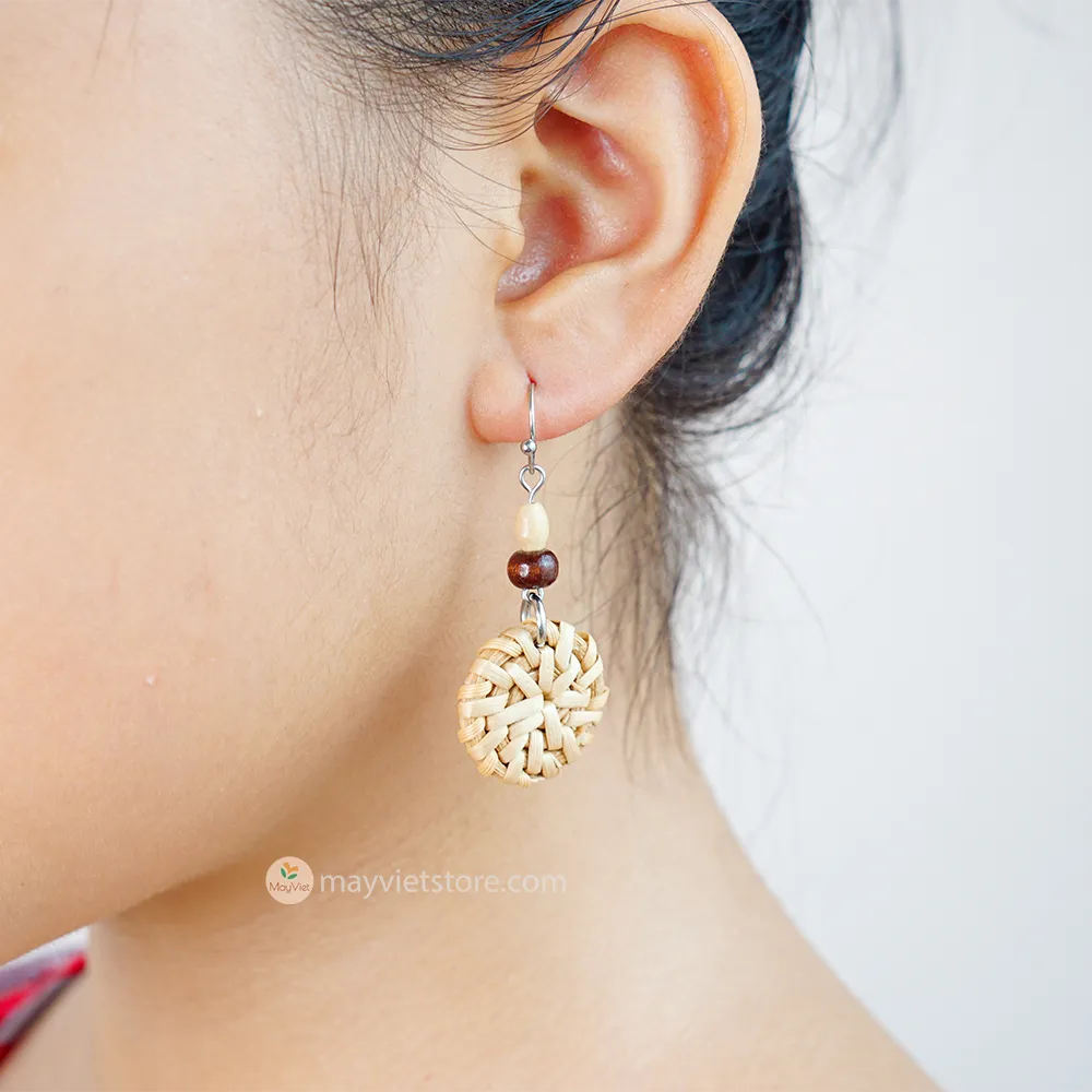 A pair of mini rattan round earrings with wooden beads, handcrafted by Mayvietstore. The earrings are made of high-quality rattan and wood, and are lightweight and comfortable to wear. They are perfect for everyday wear or for special occasions.