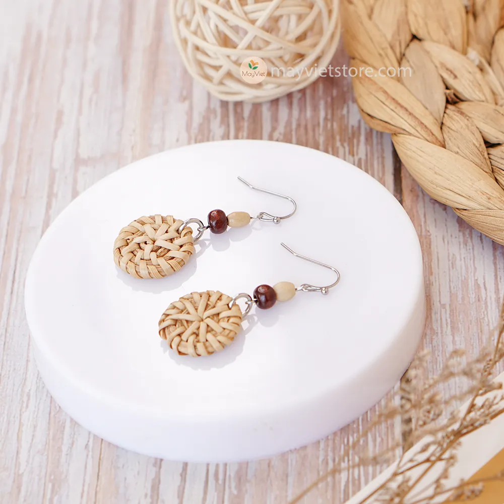 A pair of mini rattan round earrings with wooden beads, handcrafted by Mayvietstore. The earrings are made of high-quality rattan and wood, and are lightweight and comfortable to wear. They are perfect for everyday wear or for special occasions.