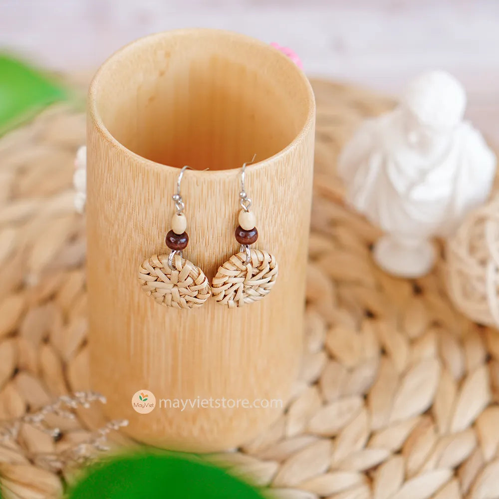 A pair of mini rattan round earrings with wooden beads, handcrafted by Mayvietstore. The earrings are made of high-quality rattan and wood, and are lightweight and comfortable to wear. They are perfect for everyday wear or for special occasions.