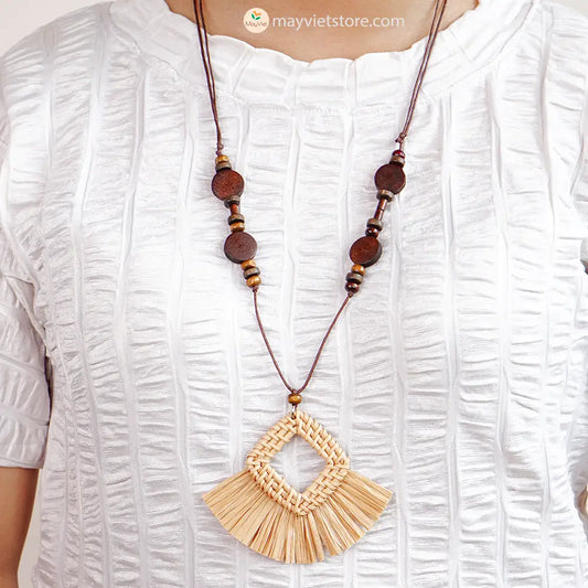 This rattan tassel wooden beads necklace is a fun and flirty accessory. The rattan is lightweight and comfortable to wear, while the wooden beads add a touch of natural beauty. The tassel is long and flowy, making this necklace a statement piece. This necklace is perfect for any occasion, from a casual day out to a summer party.