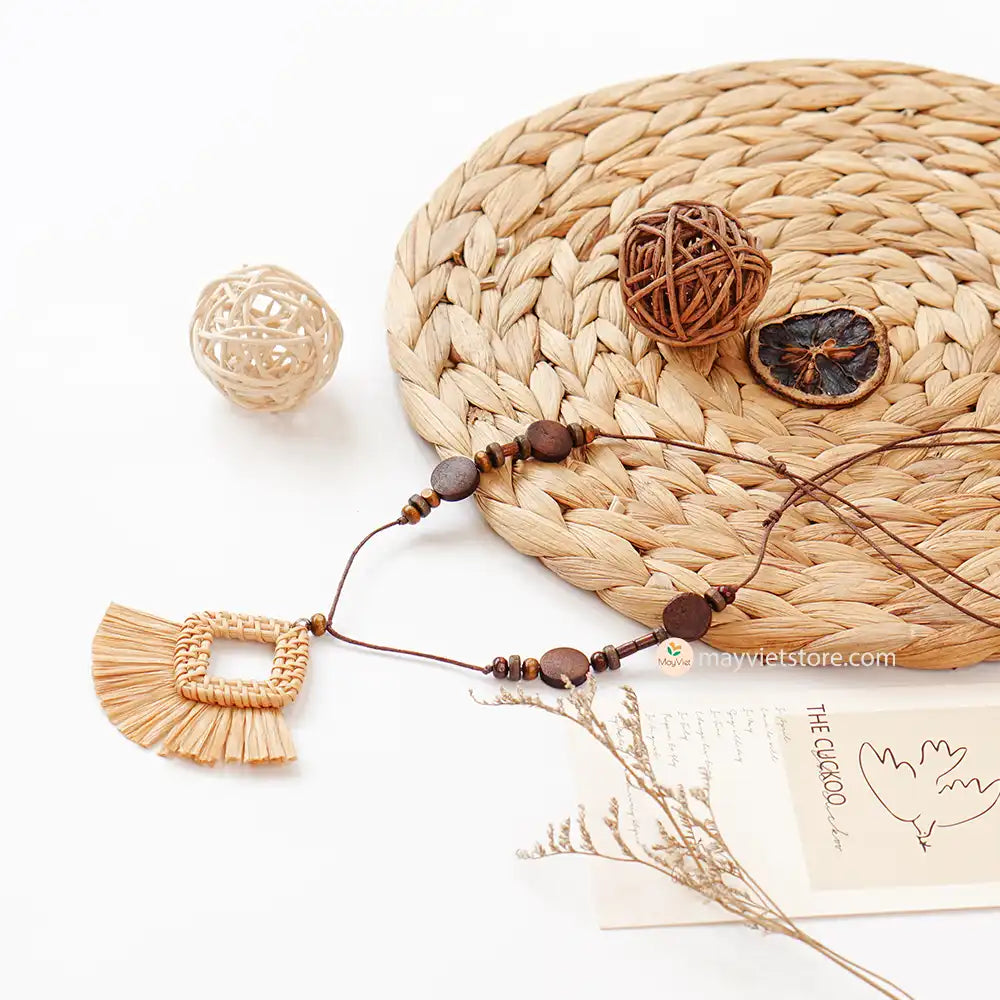 This rattan tassel wooden beads necklace is a fun and flirty accessory. The rattan is lightweight and comfortable to wear, while the wooden beads add a touch of natural beauty. The tassel is long and flowy, making this necklace a statement piece. This necklace is perfect for any occasion, from a casual day out to a summer party.
