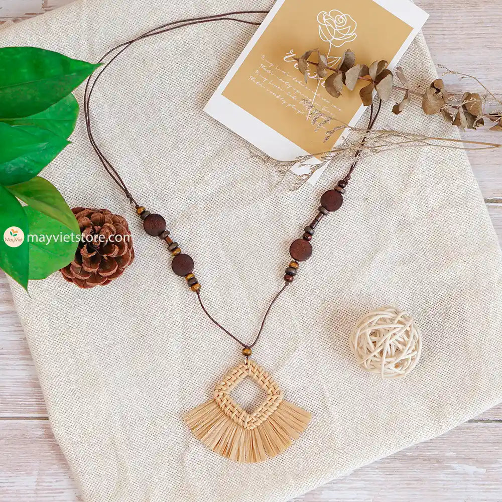 This rattan tassel wooden beads necklace is a fun and flirty accessory. The rattan is lightweight and comfortable to wear, while the wooden beads add a touch of natural beauty. The tassel is long and flowy, making this necklace a statement piece. This necklace is perfect for any occasion, from a casual day out to a summer party.