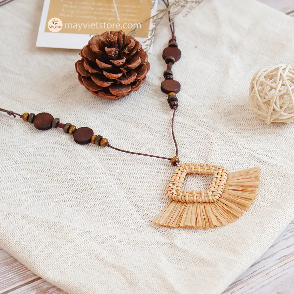 This rattan tassel wooden beads necklace is a fun and flirty accessory. The rattan is lightweight and comfortable to wear, while the wooden beads add a touch of natural beauty. The tassel is long and flowy, making this necklace a statement piece. This necklace is perfect for any occasion, from a casual day out to a summer party.