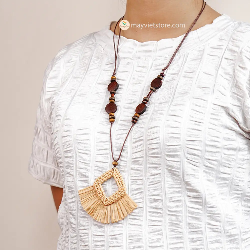 This rattan tassel wooden beads necklace is a fun and flirty accessory. The rattan is lightweight and comfortable to wear, while the wooden beads add a touch of natural beauty. The tassel is long and flowy, making this necklace a statement piece. This necklace is perfect for any occasion, from a casual day out to a summer party.