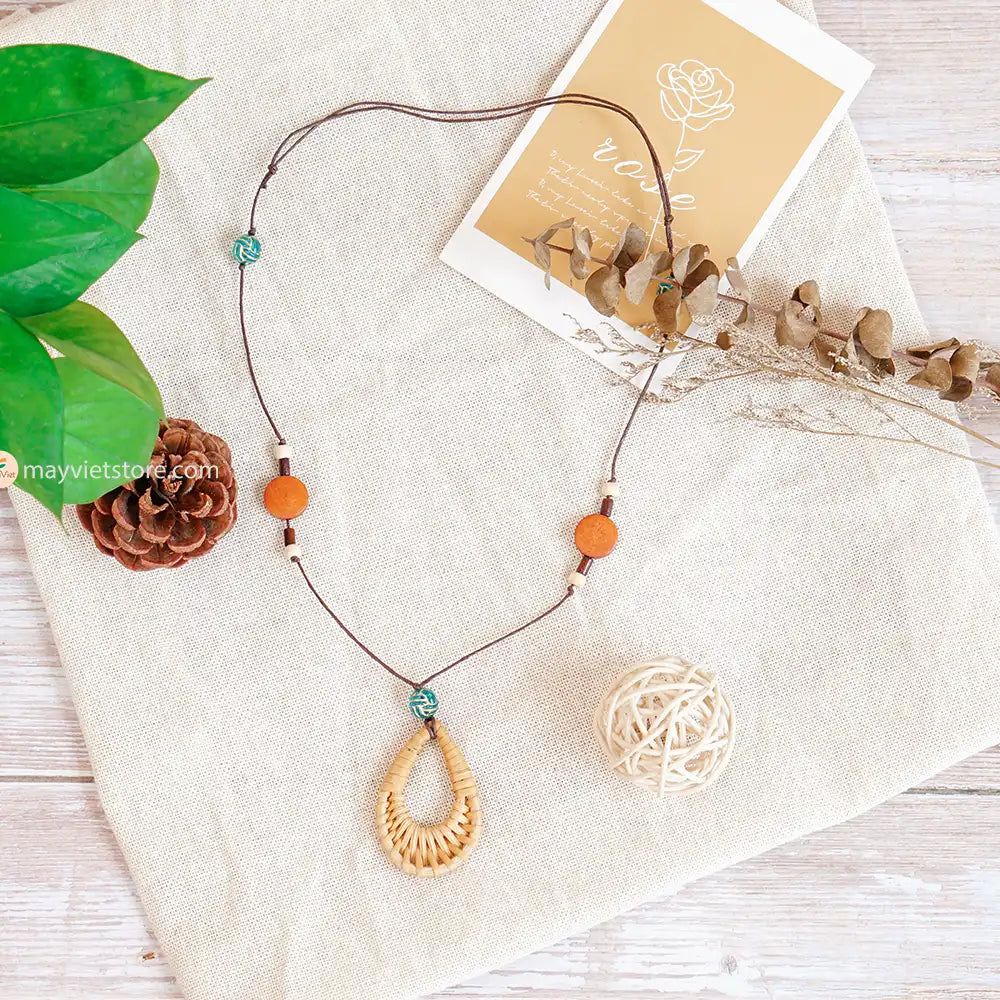 This rattan teardrop wooden beads necklace is a beautiful and elegant accessory. The rattan is lightweight and comfortable to wear, while the wooden beads add a touch of natural beauty. The teardrop shape is flattering and feminine, making this necklace perfect for any occasion.