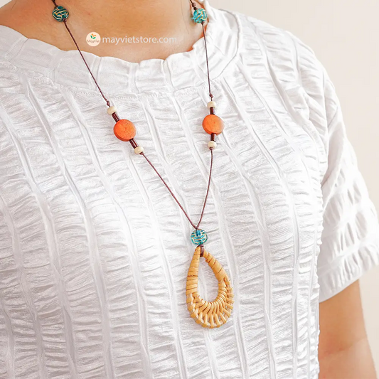 This rattan teardrop wooden beads necklace is a beautiful and elegant accessory. The rattan is lightweight and comfortable to wear, while the wooden beads add a touch of natural beauty. The teardrop shape is flattering and feminine, making this necklace perfect for any occasion.