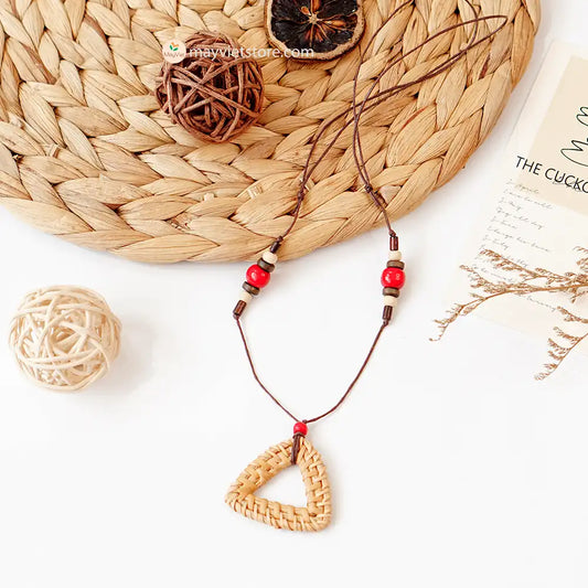 This rattan triangle wooden beads necklace is a unique and stylish accessory. The rattan is lightweight and comfortable to wear, while the wooden beads add a touch of natural beauty. The triangle shape is geometric and modern, making this necklace perfect for any occasion.
