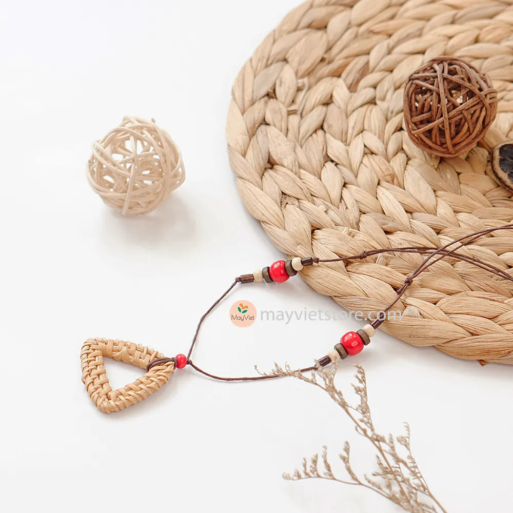 This rattan triangle wooden beads necklace is a unique and stylish accessory. The rattan is lightweight and comfortable to wear, while the wooden beads add a touch of natural beauty. The triangle shape is geometric and modern, making this necklace perfect for any occasion.