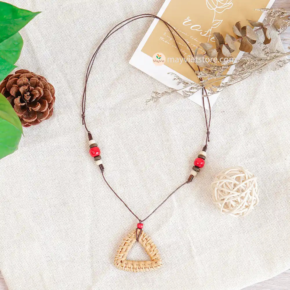 This rattan triangle wooden beads necklace is a unique and stylish accessory. The rattan is lightweight and comfortable to wear, while the wooden beads add a touch of natural beauty. The triangle shape is geometric and modern, making this necklace perfect for any occasion.