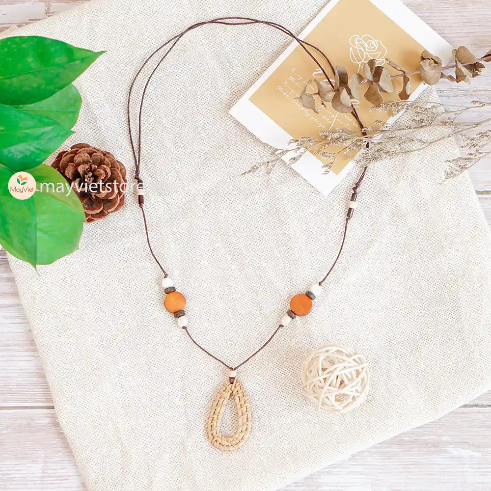 This rattan teardrop wooden beads necklace is a unique and stylish accessory. The rattan is lightweight and comfortable to wear, while the wooden beads add a touch of natural beauty. The teardrop shape is flattering and feminine, making this necklace perfect for any occasion.