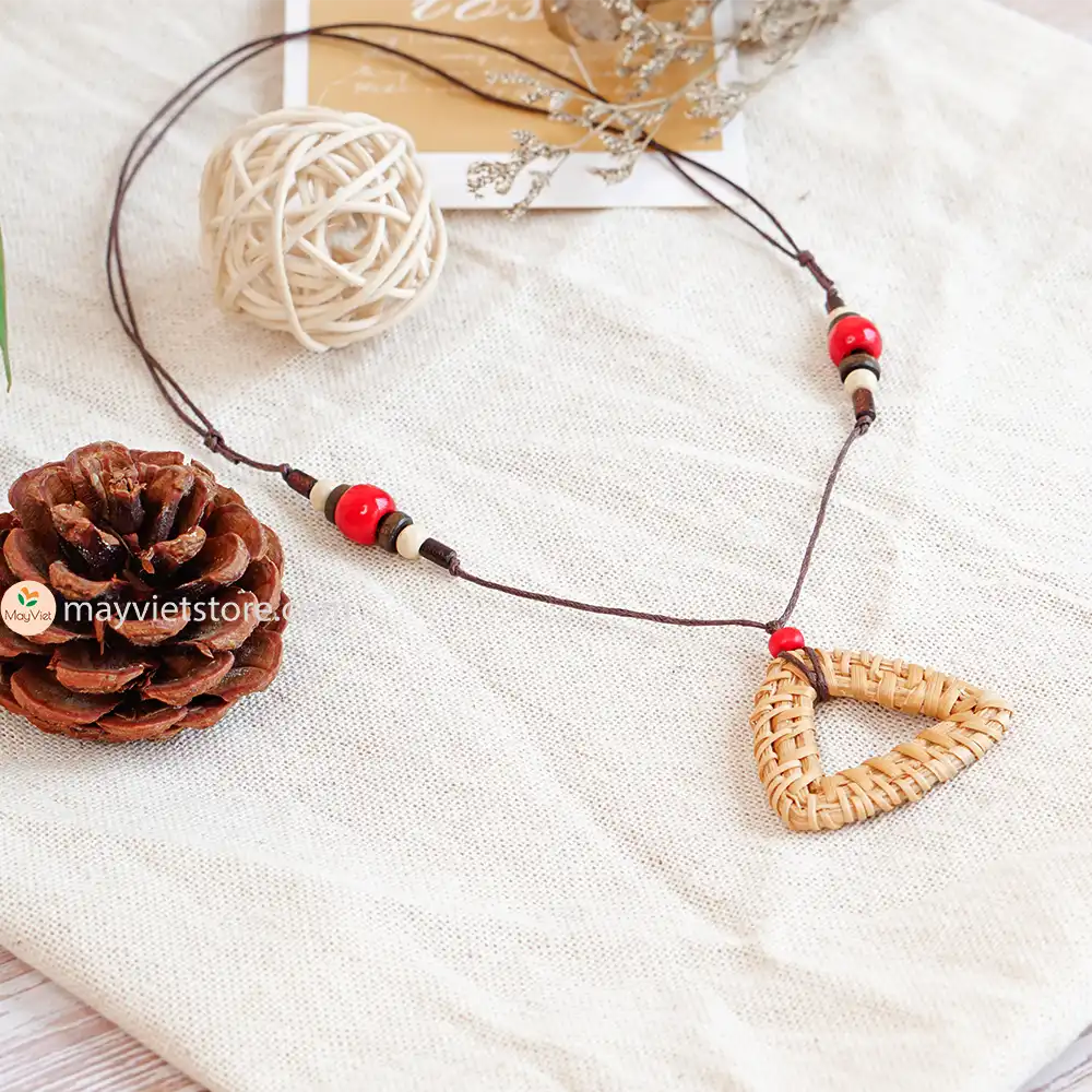 This rattan triangle wooden beads necklace is a unique and stylish accessory. The rattan is lightweight and comfortable to wear, while the wooden beads add a touch of natural beauty. The triangle shape is geometric and modern, making this necklace perfect for any occasion.