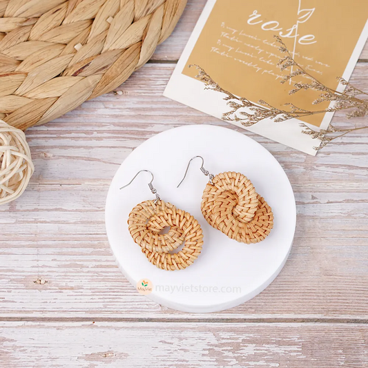 A pair of handcrafted rattan wicker round double earrings, made by Mayvietstore. The earrings are made of high-quality rattan wicker, and are lightweight and comfortable to wear. The double layered design adds a touch of interest and personality, and the rattan wicker gives the earrings a bohemian vibe. These earrings are perfect for any occasion, from a casual day out to a special event.