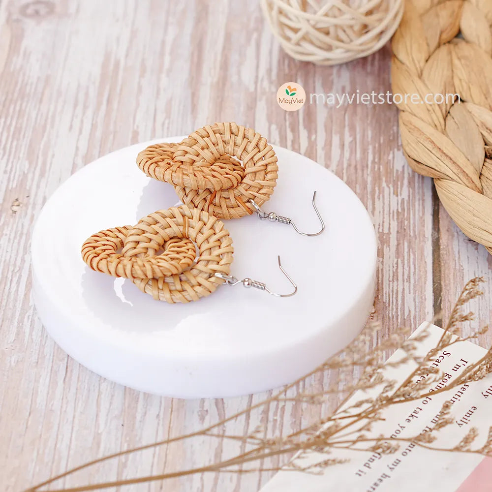 A pair of handcrafted rattan wicker round double earrings, made by Mayvietstore. The earrings are made of high-quality rattan wicker, and are lightweight and comfortable to wear. The double layered design adds a touch of interest and personality, and the rattan wicker gives the earrings a bohemian vibe. These earrings are perfect for any occasion, from a casual day out to a special event.