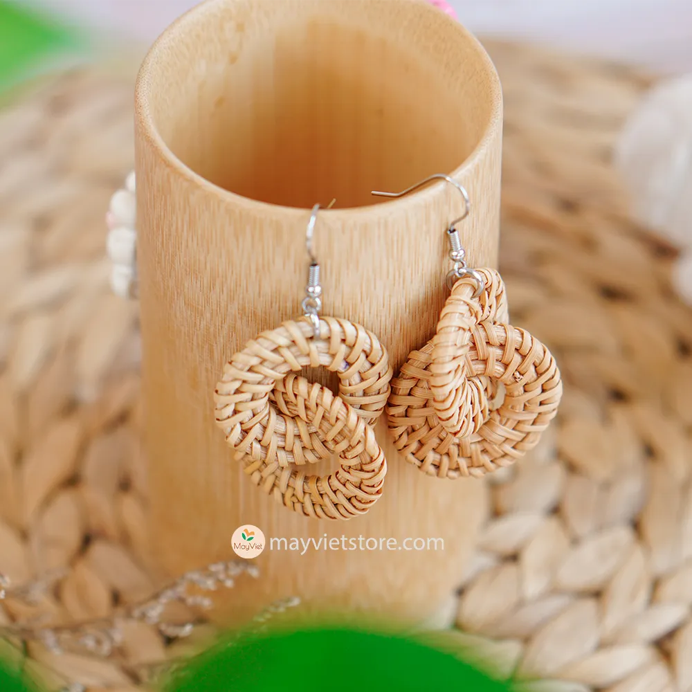 A pair of handcrafted rattan wicker round double earrings, made by Mayvietstore. The earrings are made of high-quality rattan wicker, and are lightweight and comfortable to wear. The double layered design adds a touch of interest and personality, and the rattan wicker gives the earrings a bohemian vibe. These earrings are perfect for any occasion, from a casual day out to a special event.