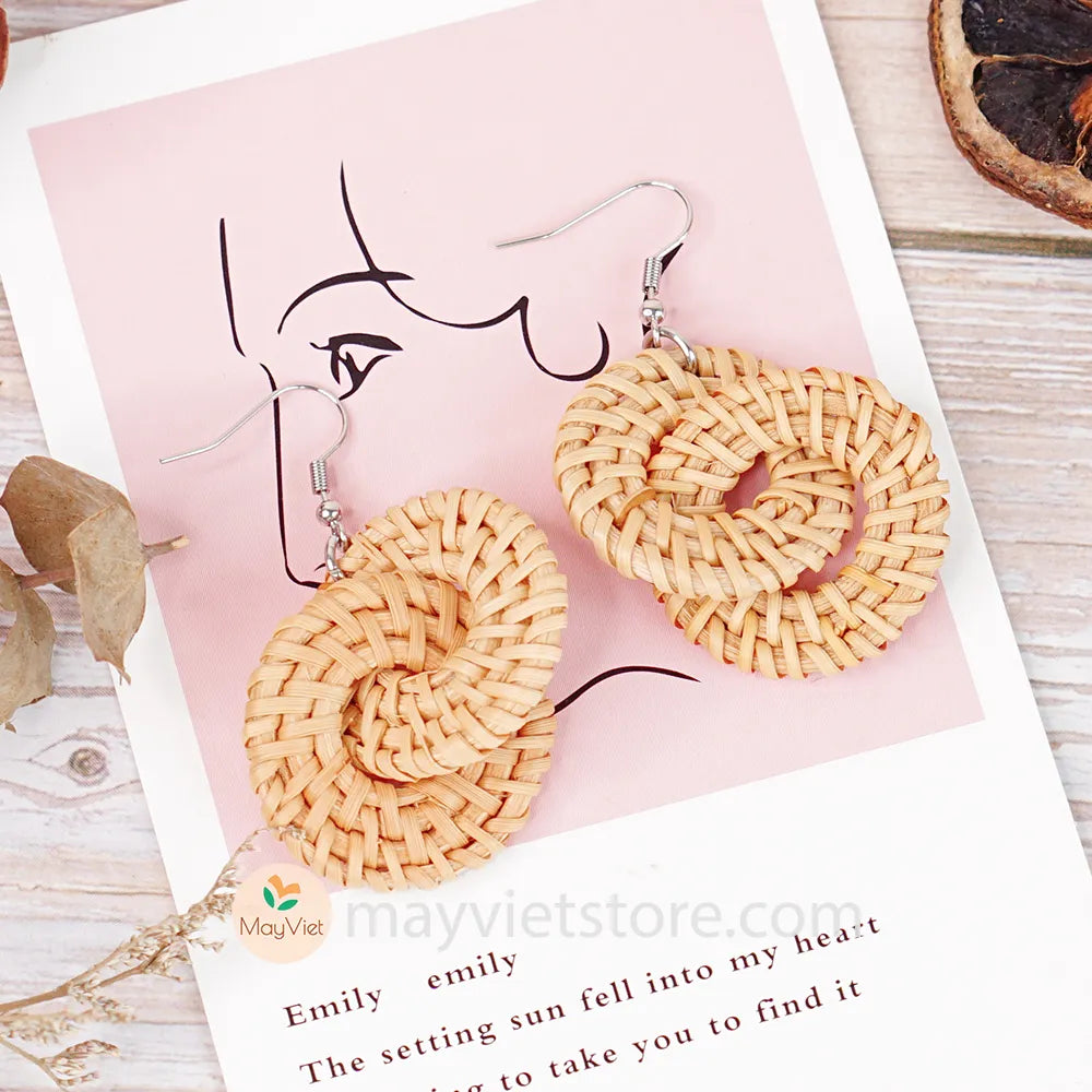 A pair of handcrafted rattan wicker round double earrings, made by Mayvietstore. The earrings are made of high-quality rattan wicker, and are lightweight and comfortable to wear. The double layered design adds a touch of interest and personality, and the rattan wicker gives the earrings a bohemian vibe. These earrings are perfect for any occasion, from a casual day out to a special event.