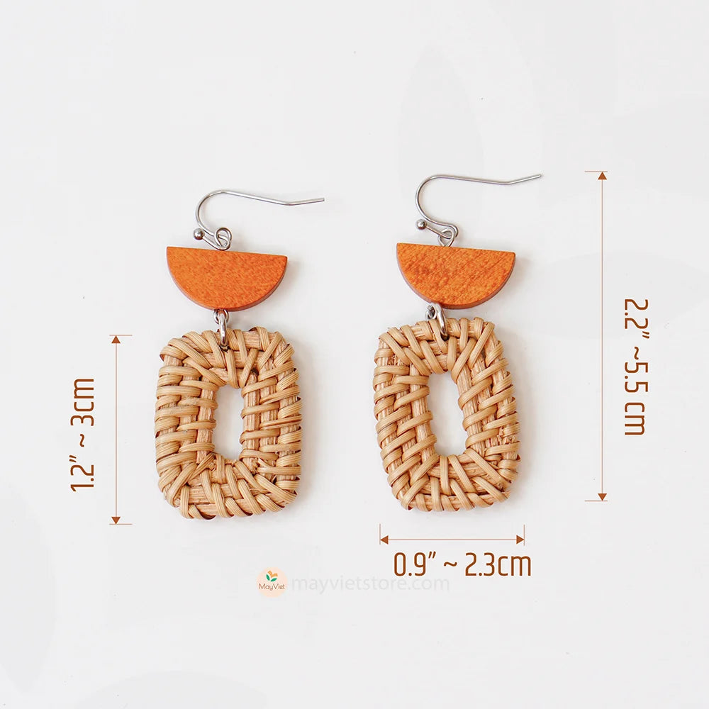 A pair of handcrafted rectangular white rattan earrings with half brown wooden beads, made by Mayvietstore. The earrings are made of high-quality rattan and wood, and are lightweight and comfortable to wear. The rectangular shape adds a touch of sophistication and elegance to the earrings, while the half brown wooden beads add a touch of natural and earthy feel. The contrast between the white rattan and the brown wood beads is eye-catching and unique. These earrings are perfect for any occasion, from a casu