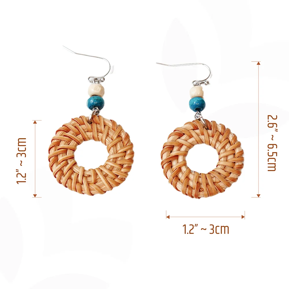 These round rattan hoop earrings with blue and white wooden beads are a fun and stylish accessory. The rattan is lightweight and comfortable to wear, while the blue and white wooden beads add a touch of nautical charm. The hoop shape is classic and versatile, making these earrings perfect for any occasion.