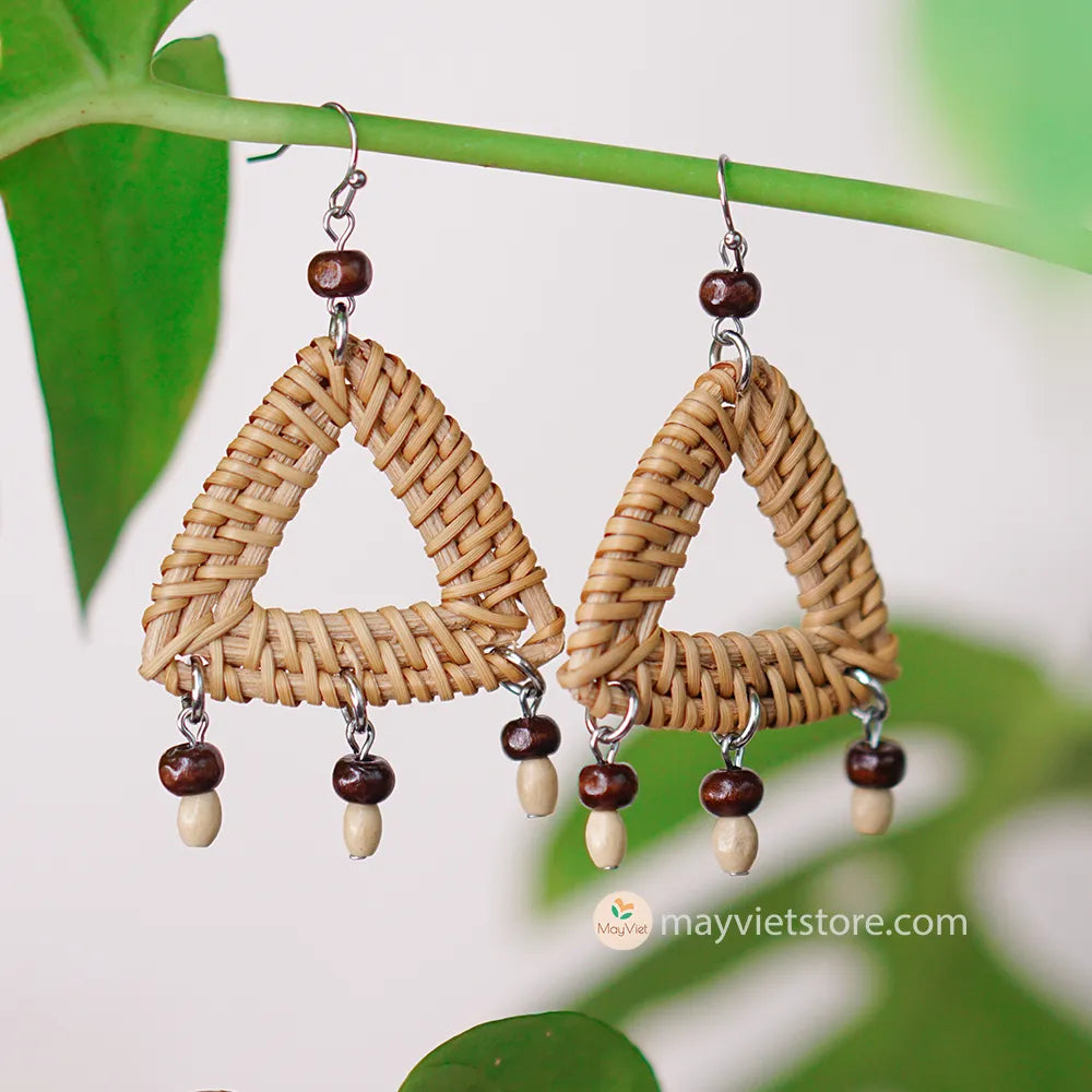 These triangle rattan earrings with brown wooden beads are a stylish and unique accessory. The rattan is lightweight and comfortable to wear, while the brown wooden beads add a touch of natural beauty. The triangle shape is geometric and modern, making these earrings perfect for any occasion.