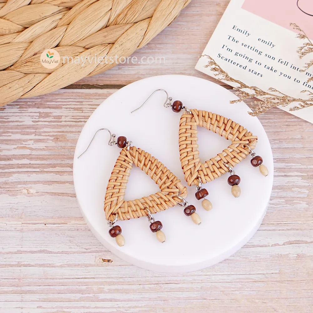 These triangle rattan earrings with brown wooden beads are a stylish and unique accessory. The rattan is lightweight and comfortable to wear, while the brown wooden beads add a touch of natural beauty. The triangle shape is geometric and modern, making these earrings perfect for any occasion.