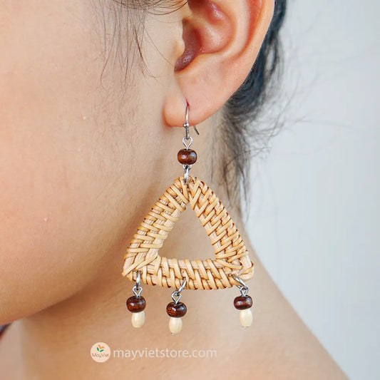 These triangle rattan earrings with brown wooden beads are a stylish and unique accessory. The rattan is lightweight and comfortable to wear, while the brown wooden beads add a touch of natural beauty. The triangle shape is geometric and modern, making these earrings perfect for any occasion.