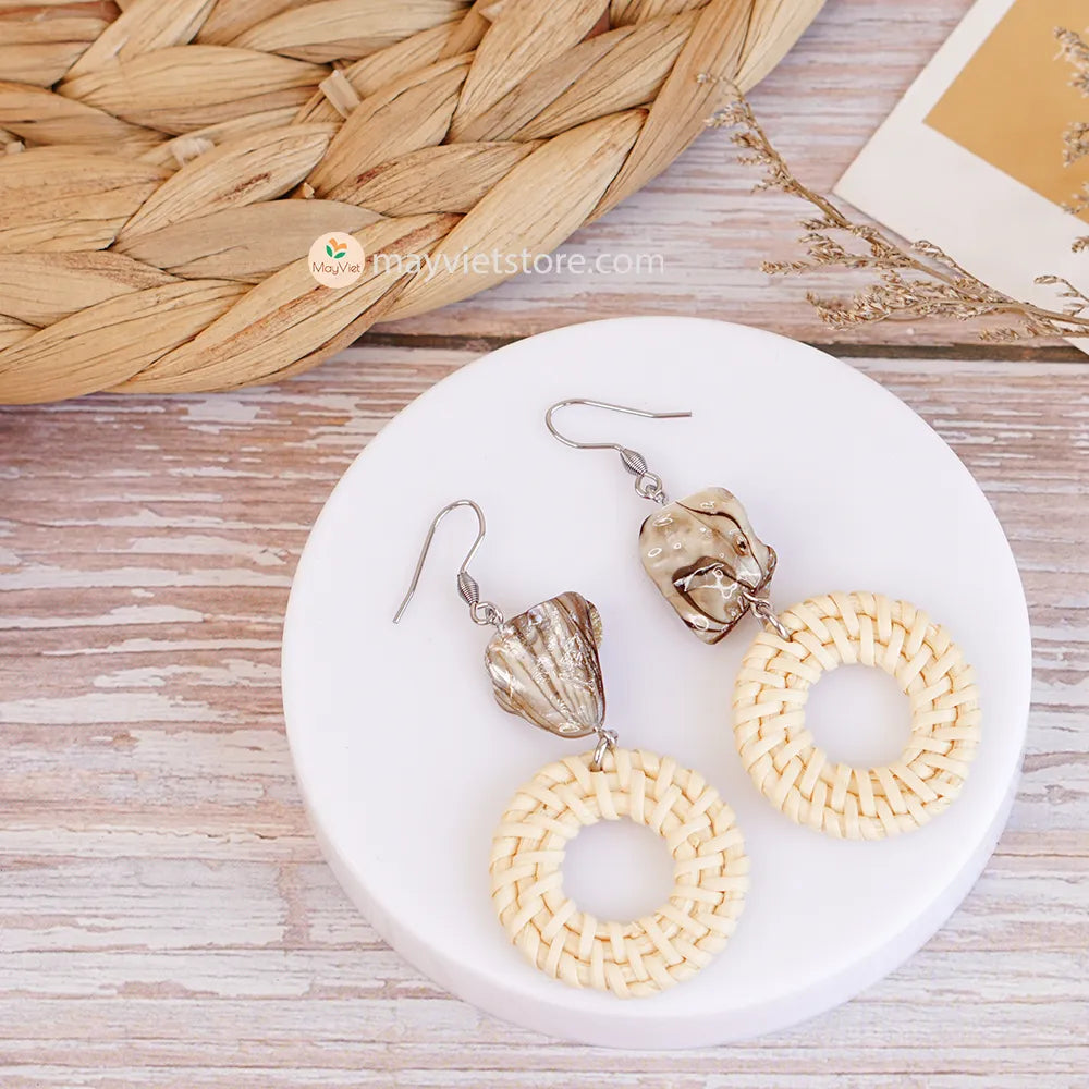 These white rattan hoop earrings with stripe stone beads are a unique and stylish accessory. The rattan is lightweight and comfortable to wear, while the stripe stone beads add a touch of sophistication and shine. The hoop shape is classic and versatile, making these earrings perfect for any occasion.