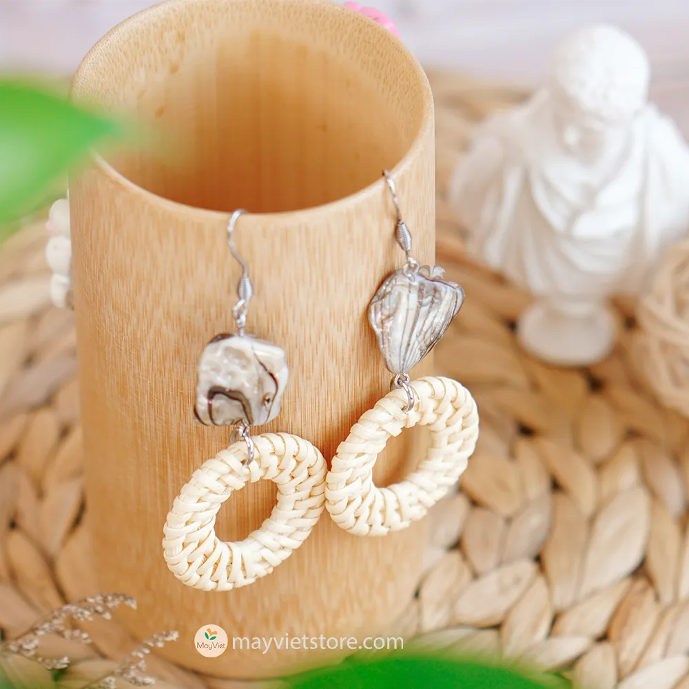 These white rattan hoop earrings with stripe stone beads are a unique and stylish accessory. The rattan is lightweight and comfortable to wear, while the stripe stone beads add a touch of sophistication and shine. The hoop shape is classic and versatile, making these earrings perfect for any occasion.