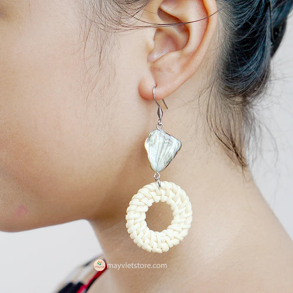 These white rattan hoop earrings with stripe stone beads are a unique and stylish accessory. The rattan is lightweight and comfortable to wear, while the stripe stone beads add a touch of sophistication and shine. The hoop shape is classic and versatile, making these earrings perfect for any occasion.